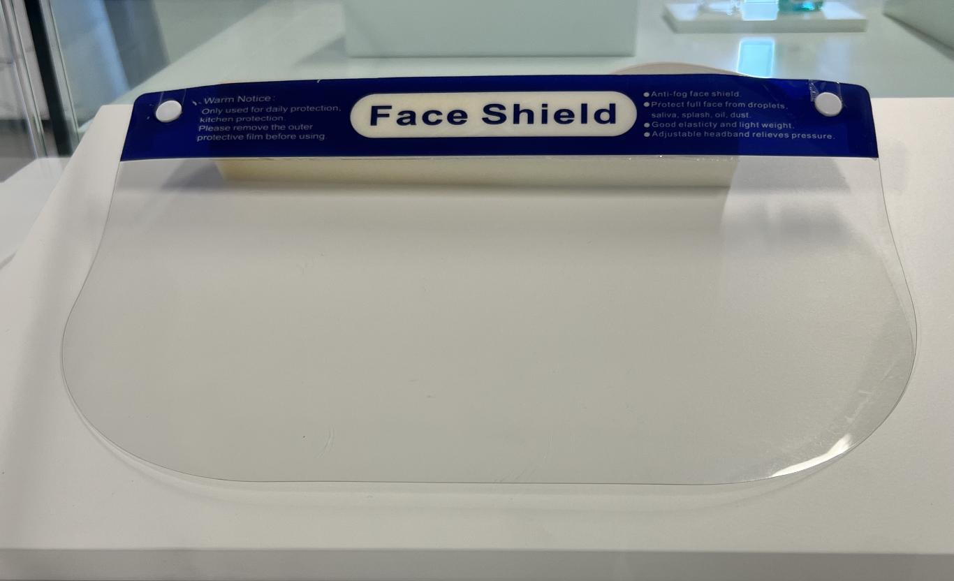 A rectangular piece of clear plastic labeled “Face Shield.”