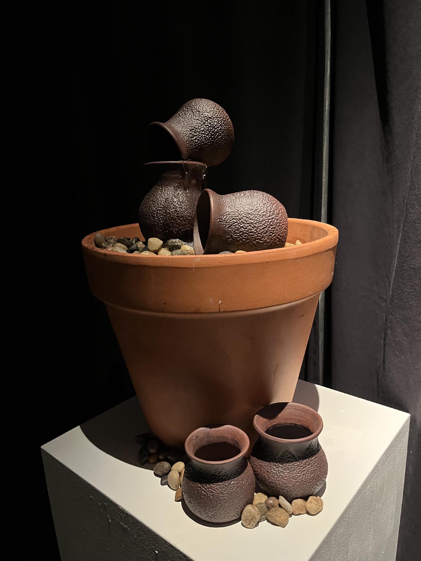 A clay pot water fountain.